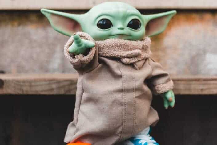 baby Yoda toy wearing sneakers