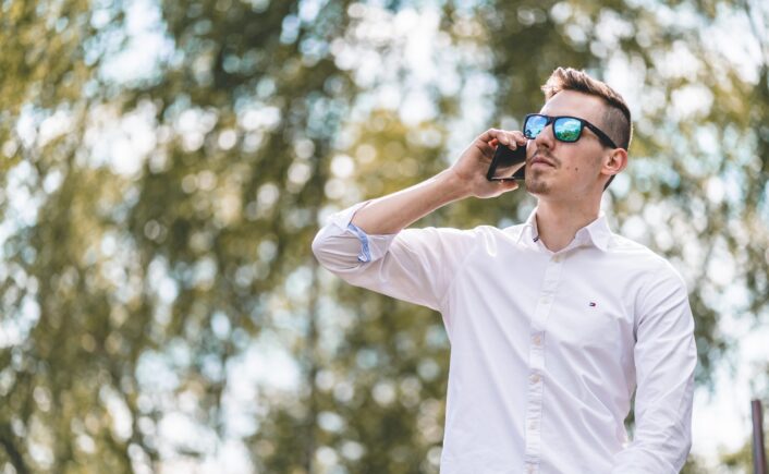 man looking upwards while on the phone