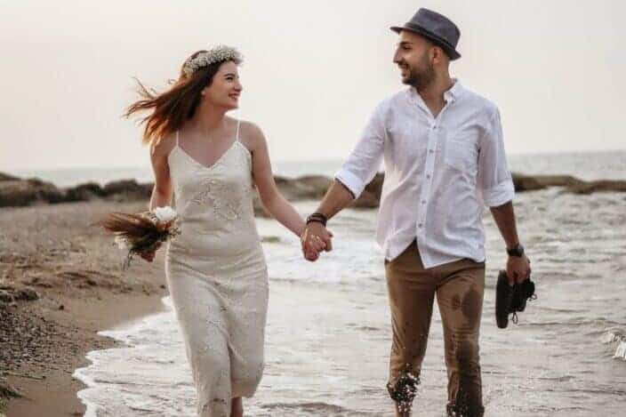 happy couple walking on seaside