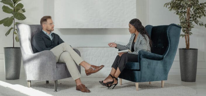 Man and woman sitting on couch