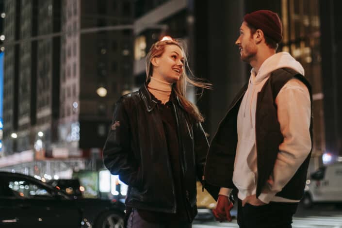 Couple holding hands and talking on the street