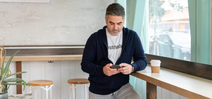 Man texting inside a coffee shop