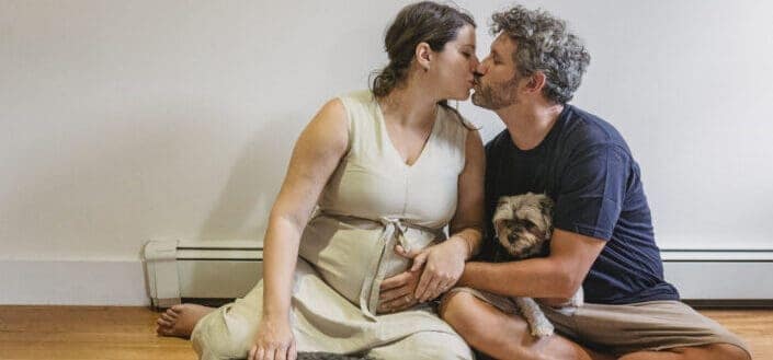 Loving pregnant couple kissing