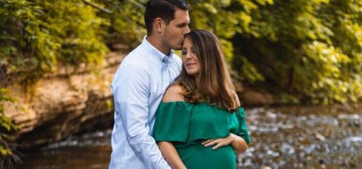 creekside backlit couple in love maternity pictures