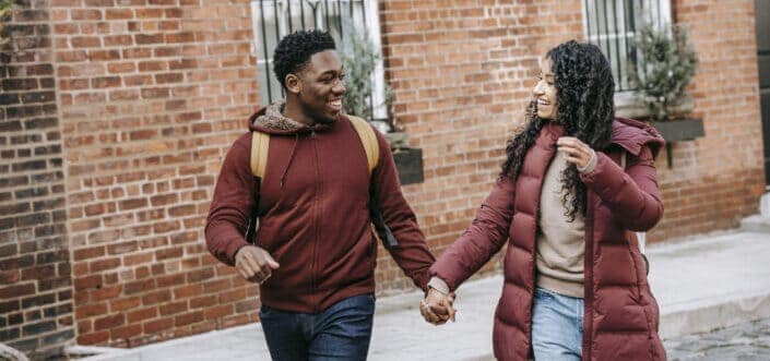 Couple holding hands while walking.