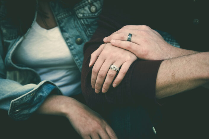 Man and woman clutching arms.