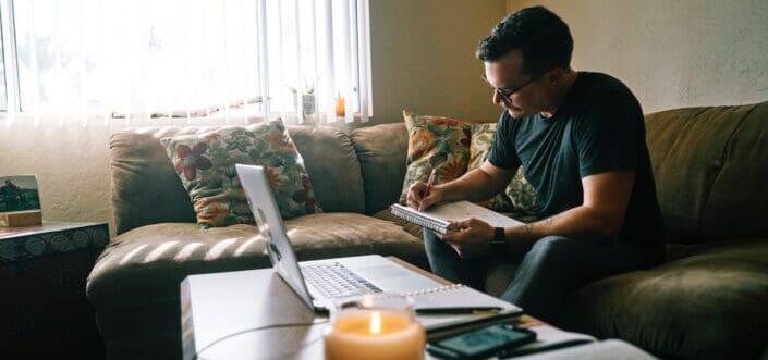 Man writing a letter while sitting