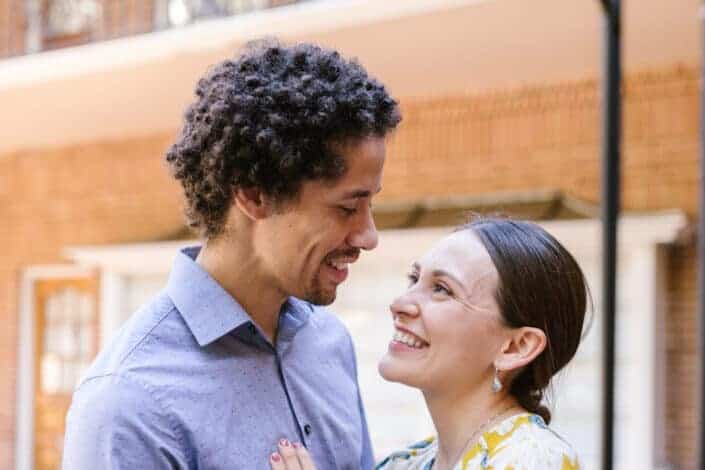 Man adorably stares at her beautifully smiling woman