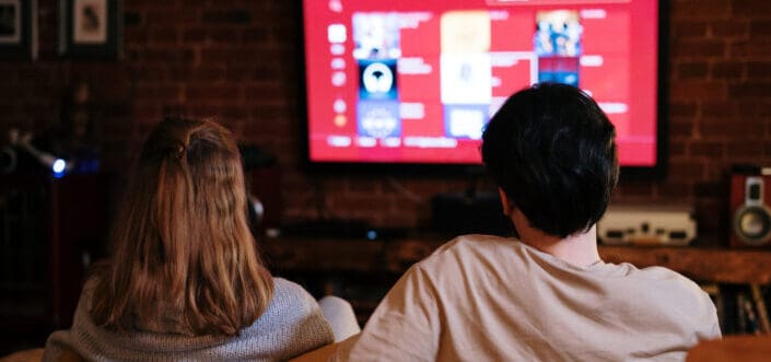 Couple sitting and watching a movie together