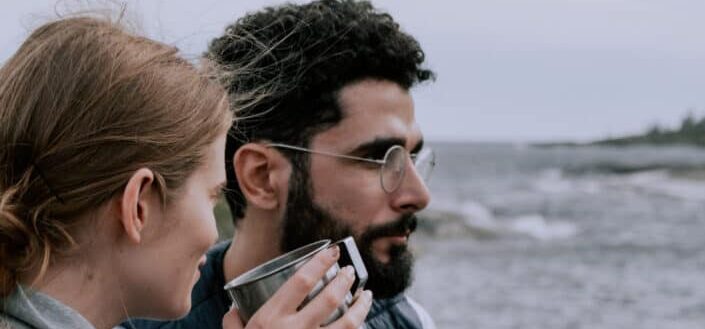 couple Holding Stainless Mugs 