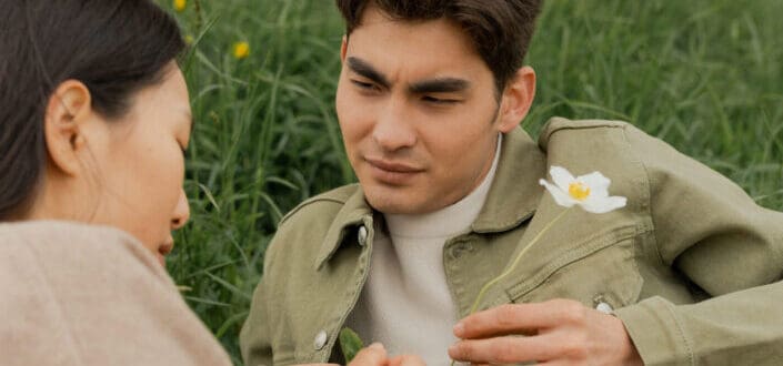 young couple flirting in the flower field