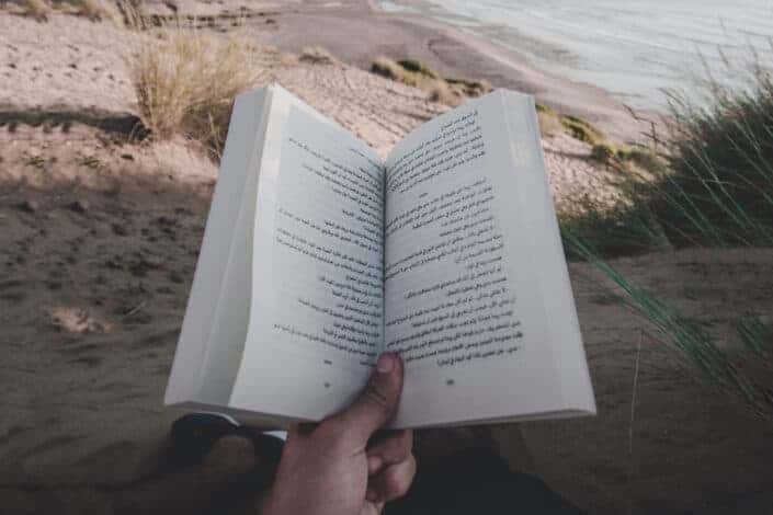 Person Reading Book On Beach