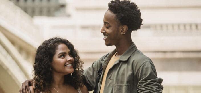 couple looking at each other near modern building