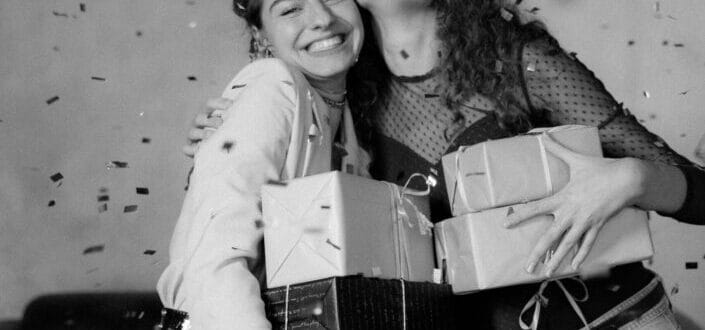 two girls holding gifts and smiling 