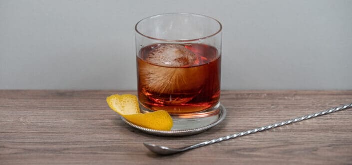 Clear drinking glass on a coaster