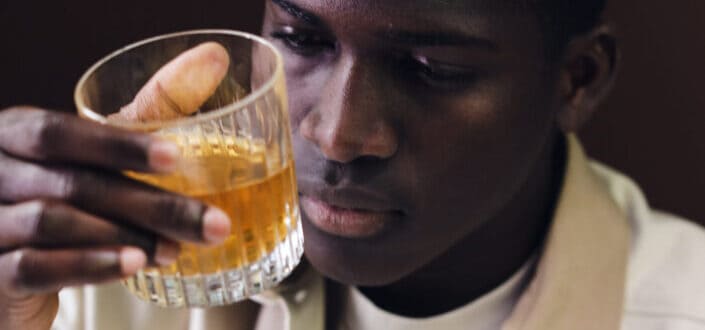 Man holding a glass of whisky