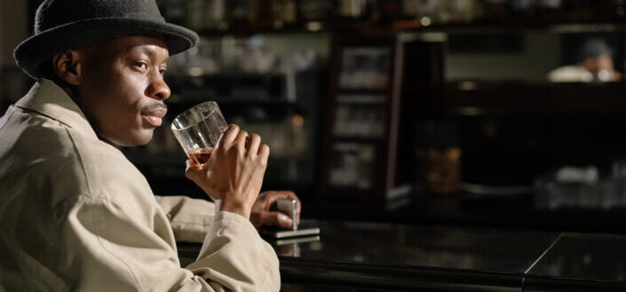 man drinking whiskey in the bar