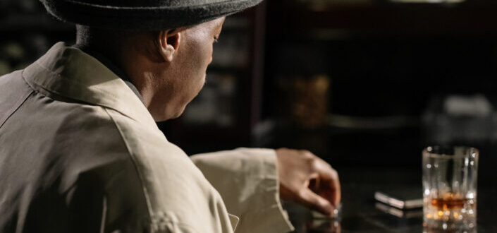 man sitting in front of bar counter