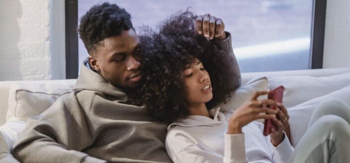 Woman Resting With Boyfriend and Using Smartphone