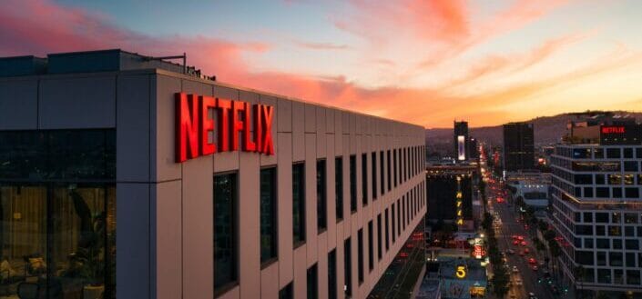 Netflix sign on a building at sunset