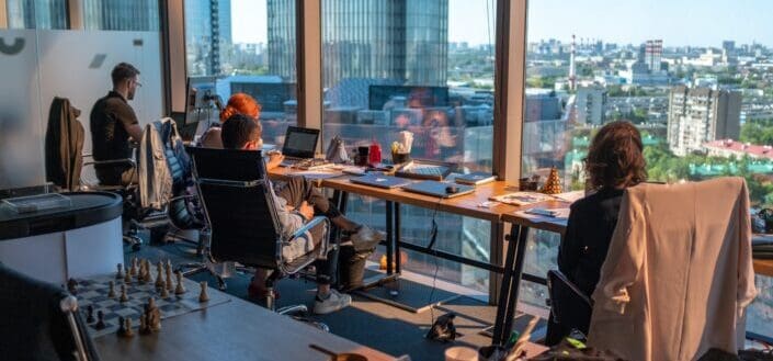 colleagues at work beside window