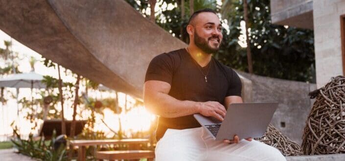 man smiling using laptop